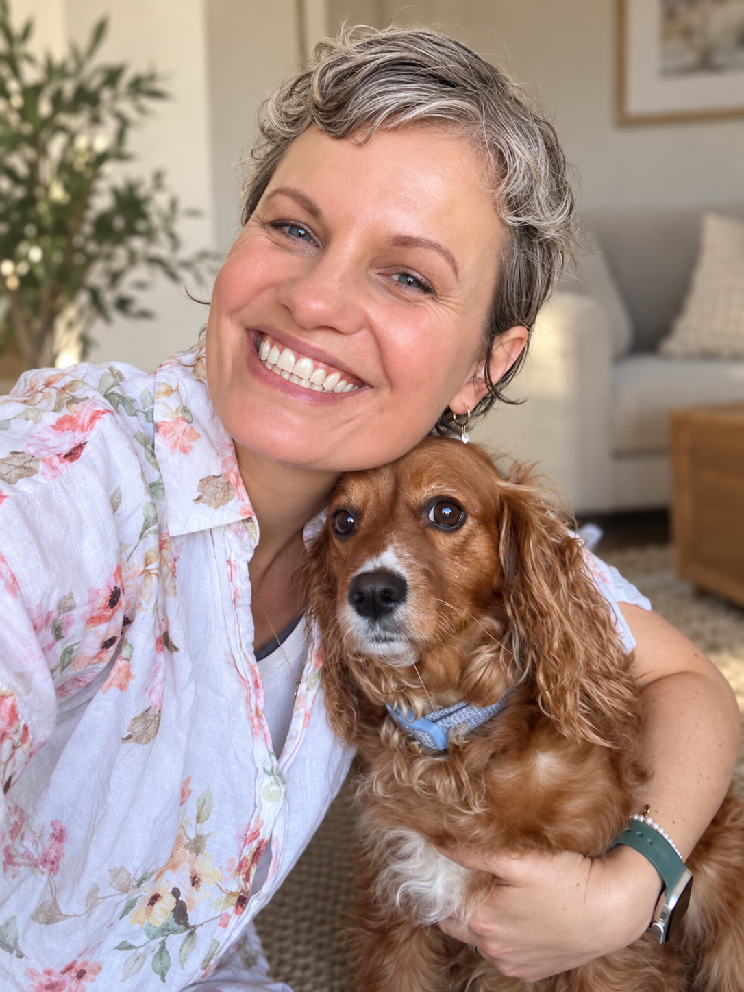 Rina Bowring smiling at home with her dog